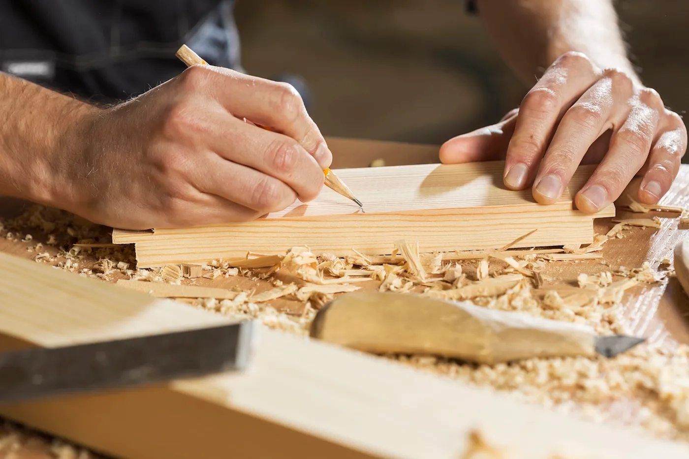 Joiner cutting timber in a workshop